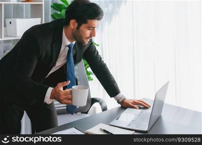 Professional businessman at modern office desk with confused expression, working on his laptop with disappointment and doubtful look. Struggle and challenging of office work. fervent. Professional businessman at modern office desk with confused expression. fervent