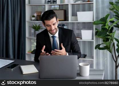 Professional businessman in black suit, present financial data or BI paper via laptop during online meeting. Remote work concept with virtual meeting presentation of effectiveness remote work. Fervent. Businessman present BI paper during online meeting. Fervent