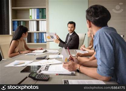 professional businessman present financial chart with team in the meeting, selective focus