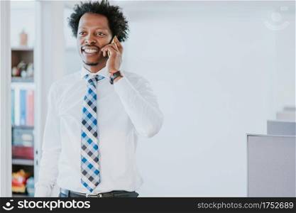 Professional businessman talking on the phone while working at modern office. Business concept.