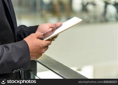 Professional businessman use digital tablet with blur background, selective focus