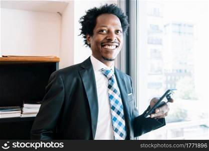 Professional businessman using his mobile phone while working at office. Business and technology concept.
