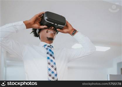 Professional businessman using virtual reality headset on a break from work at modern office. Business and technology concept.