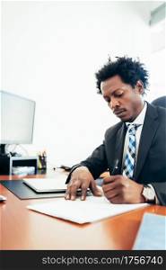 Professional businessman working with some files and documents at his modern office. Business concept.