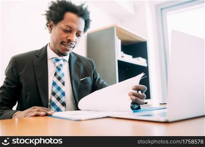 Professional businessman working with some files and documents at his modern office. Business concept.