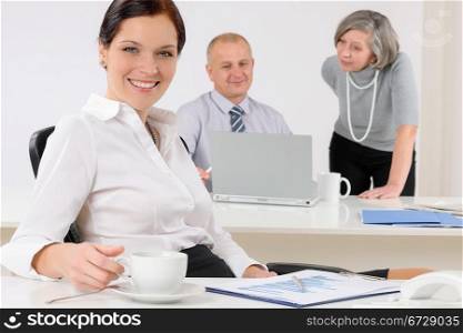 Professional businesswoman attractive drink coffee sitting by office desk