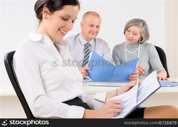 Professional businesswoman attractive sitting by office desk
