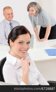 Professional businesswoman attractive sitting by office desk