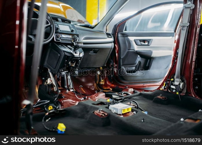 Professional car tuning, disassembled vehicle interior closeup, nobody. Auto detailing. Automobile in garage, no brand. Car tuning, disassembled vehicle interior, nobody