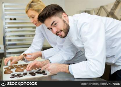 professional chefs assembling chocolate shapes