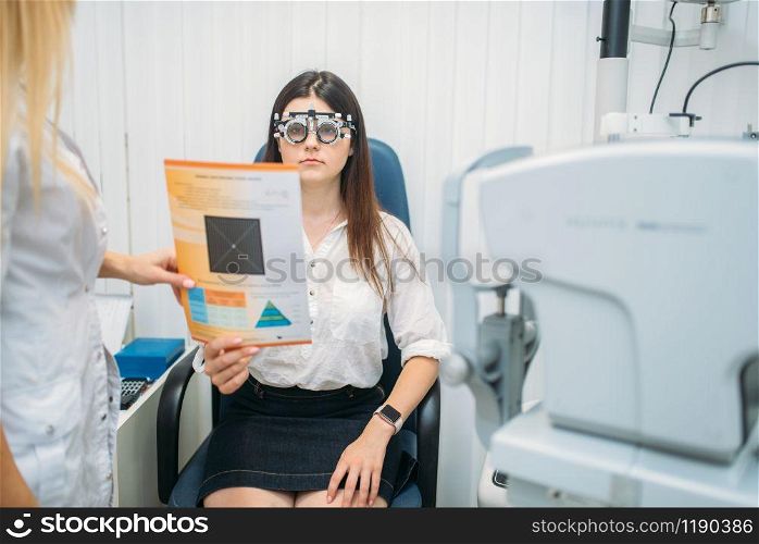 Professional choice of glasses lens, female patient on diagnostic of vision. Eyesight exam in oculist cabinet. Consultation in optician office, ophthalmology. Professional choice of glasses lens, ophthalmology