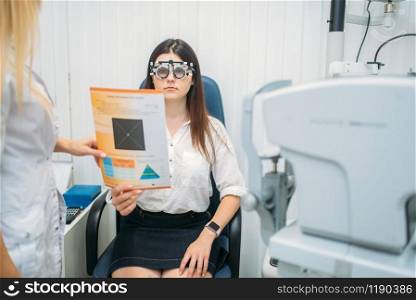 Professional choice of glasses lens, female patient on diagnostic of vision. Eyesight exam in oculist cabinet. Consultation in optician office, ophthalmology. Professional choice of glasses lens, ophthalmology