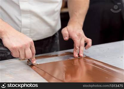Professional confectioner making chocolate sweets at confectionery shop .. Professional confectioner making chocolate sweets at confectionery shop.