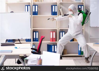 Professional contractor doing pest control at office 