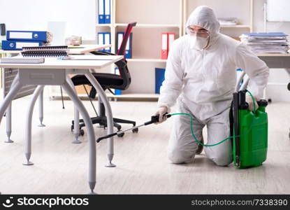 Professional contractor doing pest control at office 