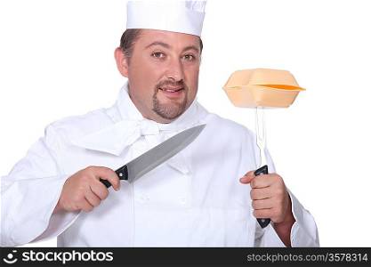 Professional cook holding knives and hamburger box