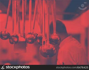 professional Cooking utensils hanging in a restaurant kitchen. professional Cooking utensils