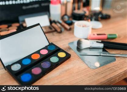 Professional cosmetics tools on wooden table, closeup. Collection of cosmetology accessories
