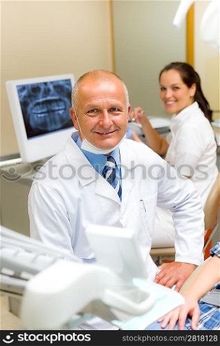 Professional dental surgeon sitting in office with assistant nurse
