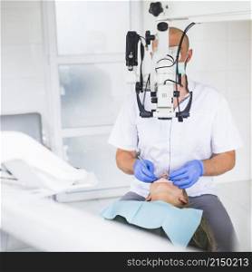 professional dentist examining patient with dental microscope