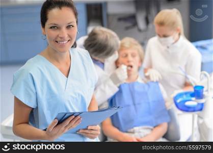 Professional dentist team checkup teenage patient boy at dental surgery