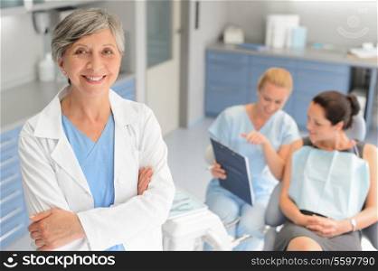 Professional dentist woman patient consultation with assistant at dental surgery