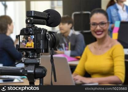 Professional digital Mirrorless camera with microphone recording video blog of Businesswoman working with Group Of Business people , Camera for photographer or Video and Live Streaming concept