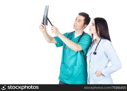 professional doctors looking at radiograph on white background