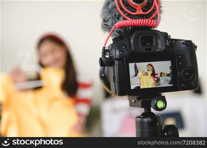 Professional DSLR digital camera film video live with vlogger blogger interview background. Woman coaching trading and review clothing product. Business presentation training class. People lifestyle