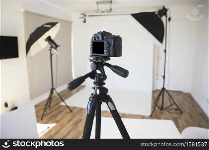 Professional dslr digital camera on tripod in photo studio