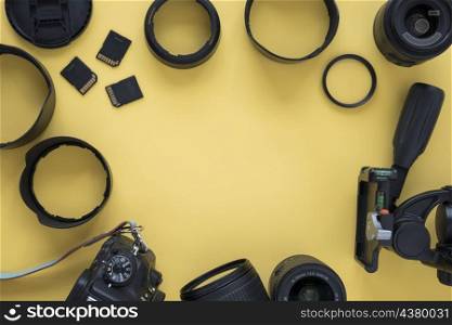 professional dslr modern camera with camera accessories yellow background
