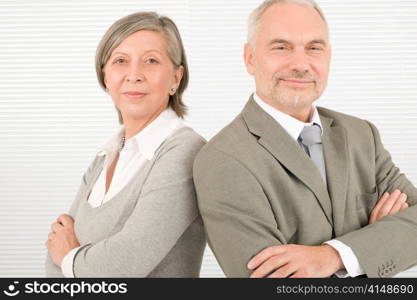 Professional elegant serious senior businesspeople standing with cross arms