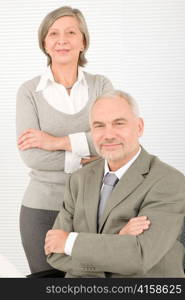 Professional elegant smiling senior businesspeople standing with cross arms