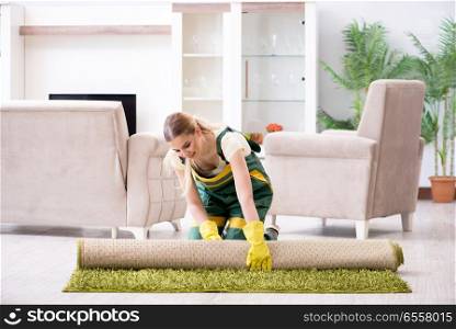 Professional female cleaner cleaning carpet