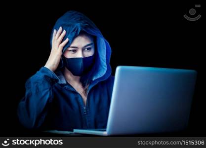 Professional hacker young women Wearing a blue robe with a hood Stealing data from online computer systems By releasing viruses into the system By using laptops and keyboards in older buildings, the concept of malware and hacker