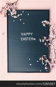 Professional high resolution studio photograph of Easter with letter board and spring flowers on pink backgrouns, flat lay. Easter background with letter board and spring flowers