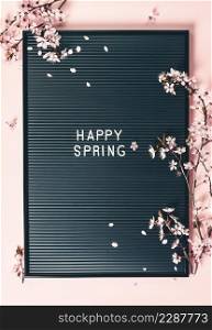 Professional high resolution studio photograph of Easter with letter board and spring flowers on pink backgrouns, flat lay
