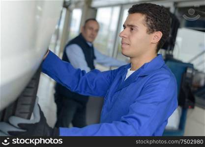 professional industrial engineer adjusting modern machine settings