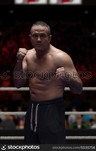 professional kickboxer with hands in martial arts position training for the fight in the training ring