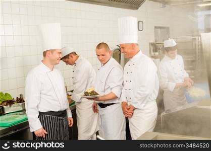 Professional kitchen busy team cooks and chef prepare meal