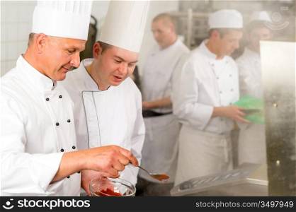 Professional kitchen chef cook add spice paprika prepare food meals