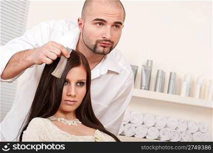 Professional male hairdresser choose hair dye color at modern salon, female customer change hair color