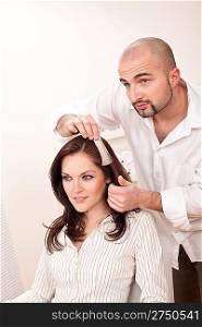 Professional male hairdresser choose hair dye color at modern salon, female customer change hair color