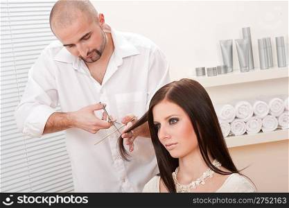 Professional male hairdresser cut with scissors at salon, customer getting new haircut