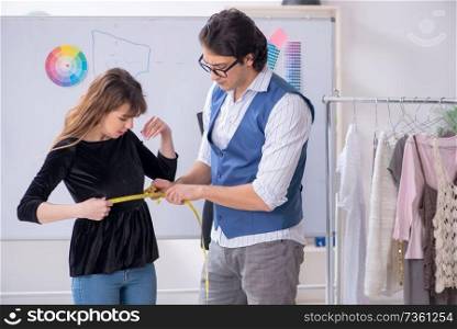 Professional male tailor taking measurements for blouse. Professional male tailor taking measurements for blouse 
