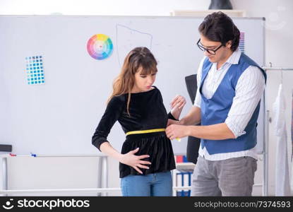 Professional male tailor taking measurements for blouse. Professional male tailor taking measurements for blouse 