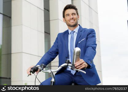 professional man on the bicycle with portable thermos