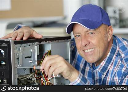 professional man repairing and assembling a computer
