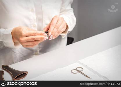 Professional manicurist preparing tools for doing clients nails. Professional manicurist preparing tools for doing clients nails.