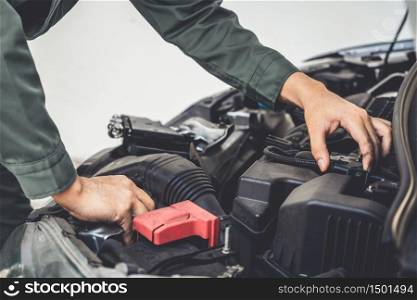 Professional mechanic hand providing car repair and maintenance service in auto garage. Car service business concept.